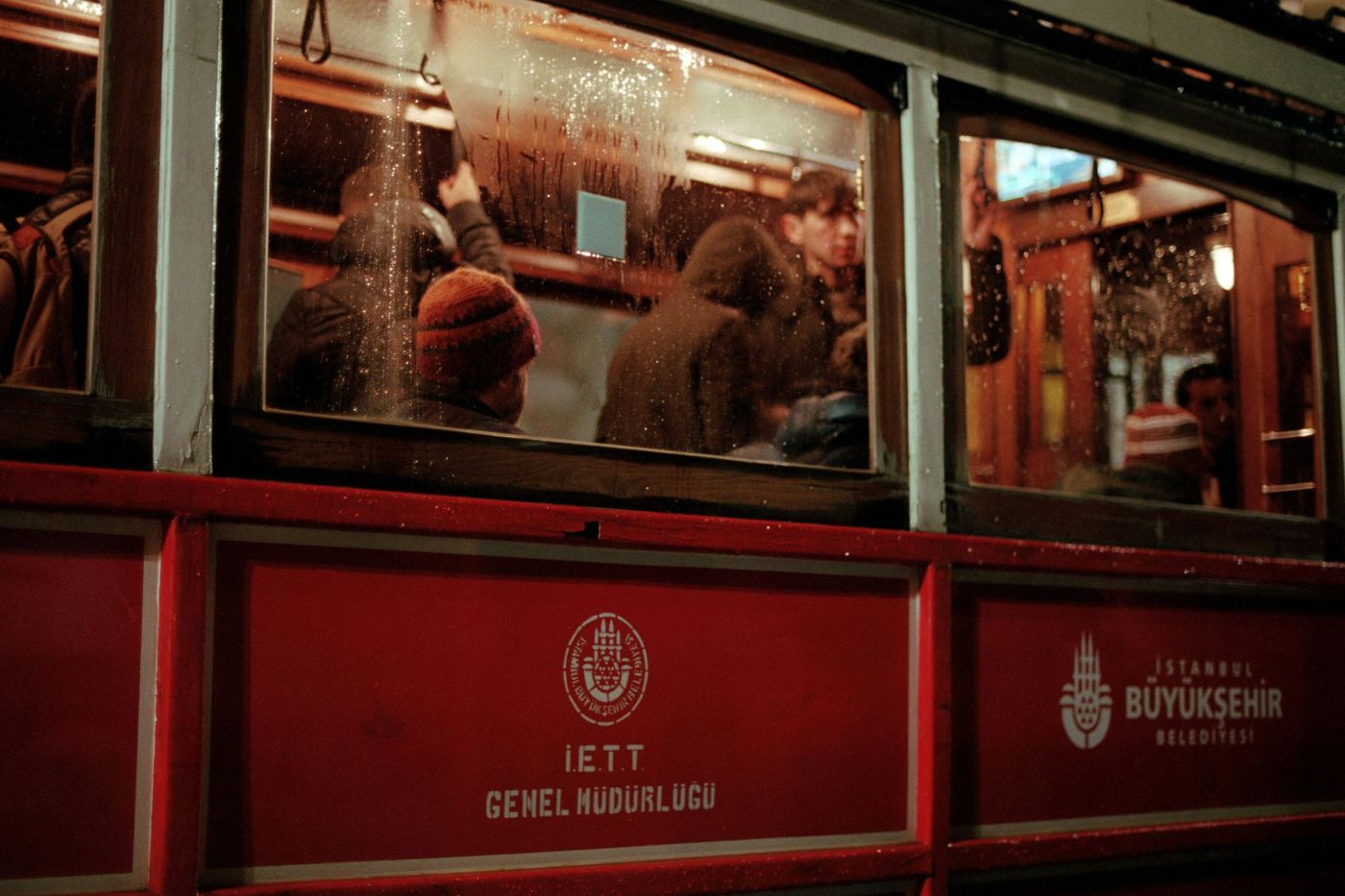 People on a red tram at night